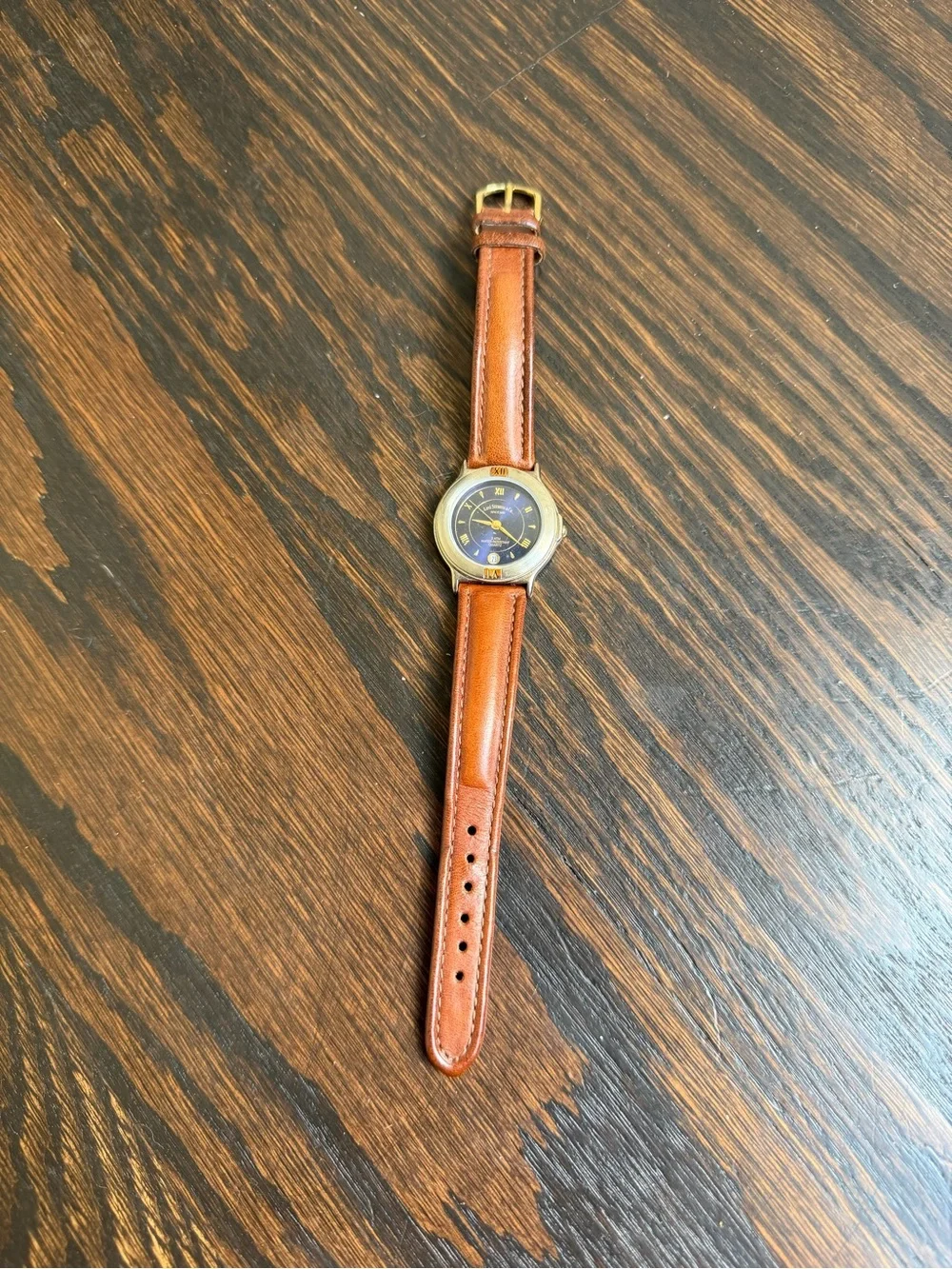 Vintage Levi’s quartz watch with a dark blue dial and a brown leather strap.